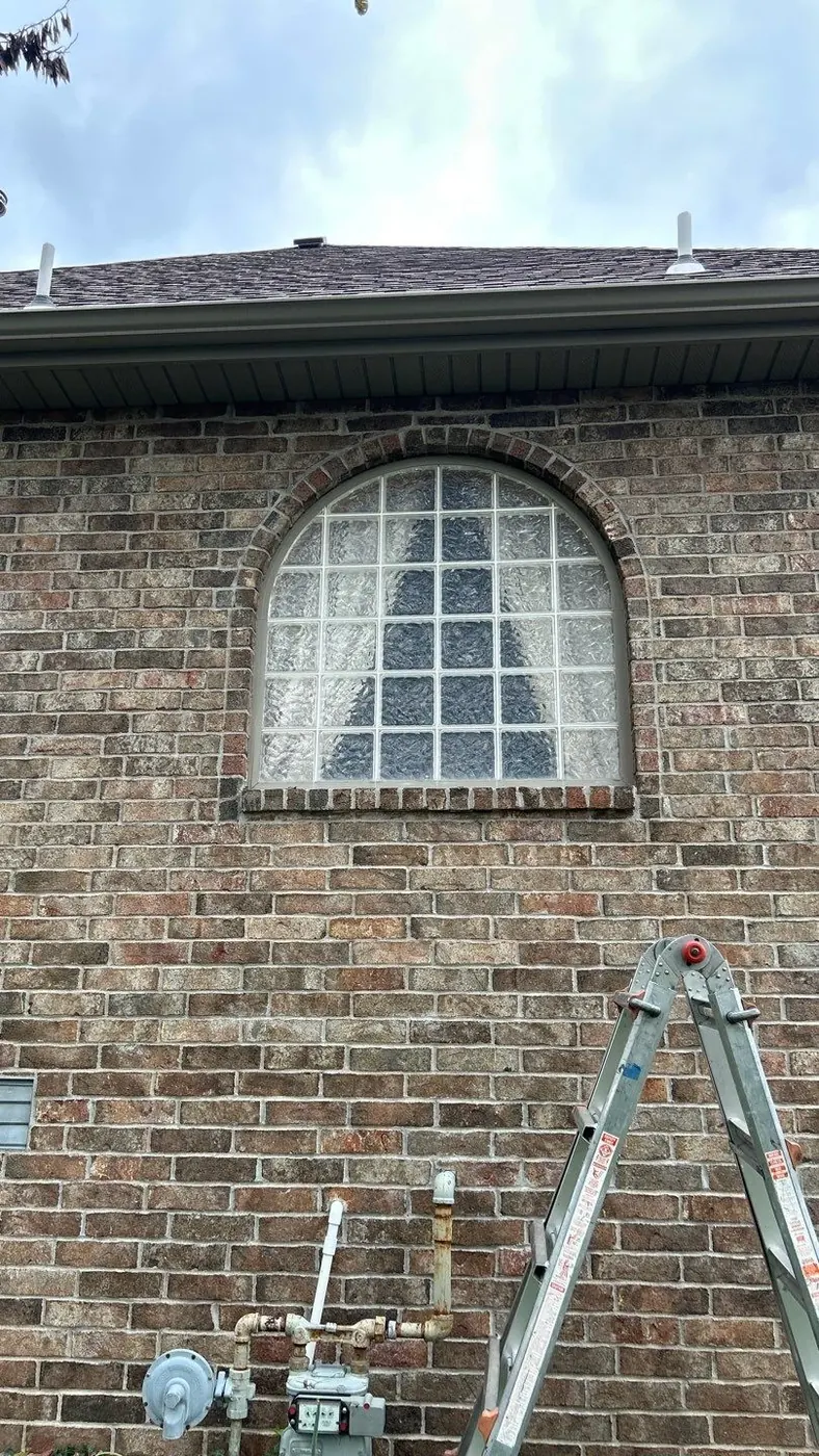 Before: the arched brick opening had an older window assembly.